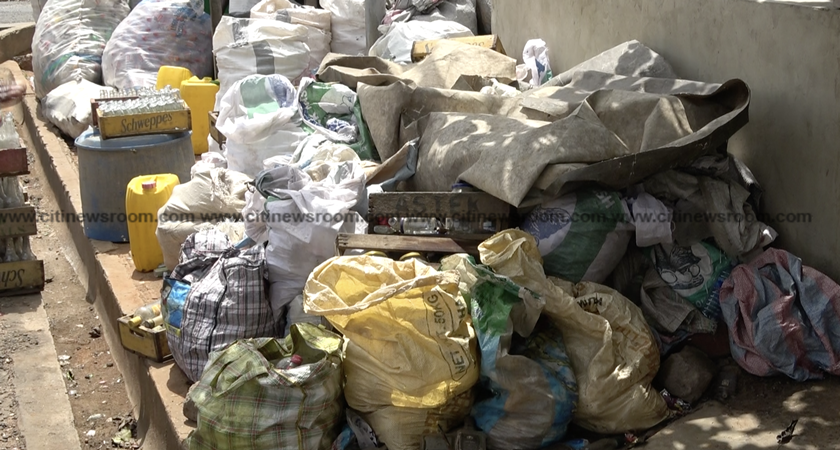 Heaps of used bottles litter Adabraka