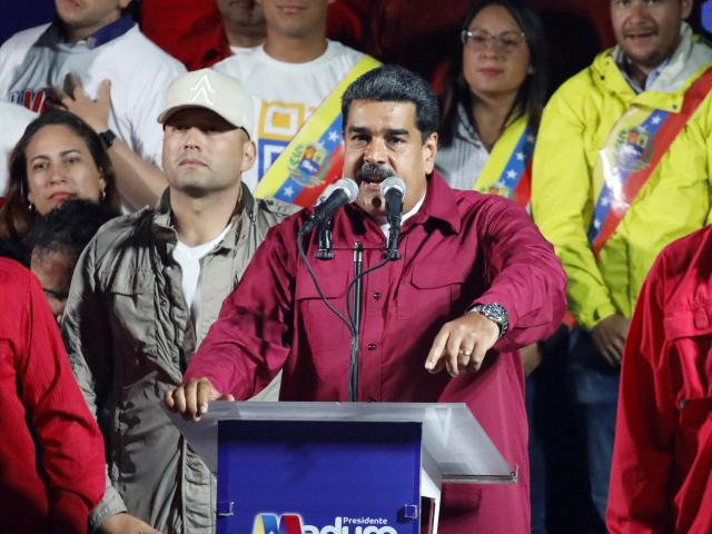 Venezuela's President Nicolas Maduro is surrounded by supporters as he speaks during a gathering after the results of the election were released, outside of the Miraflores Palace in Caracas, Venezuela, May 20, 2018. REUTERS/Carlos Garcia Rawlins