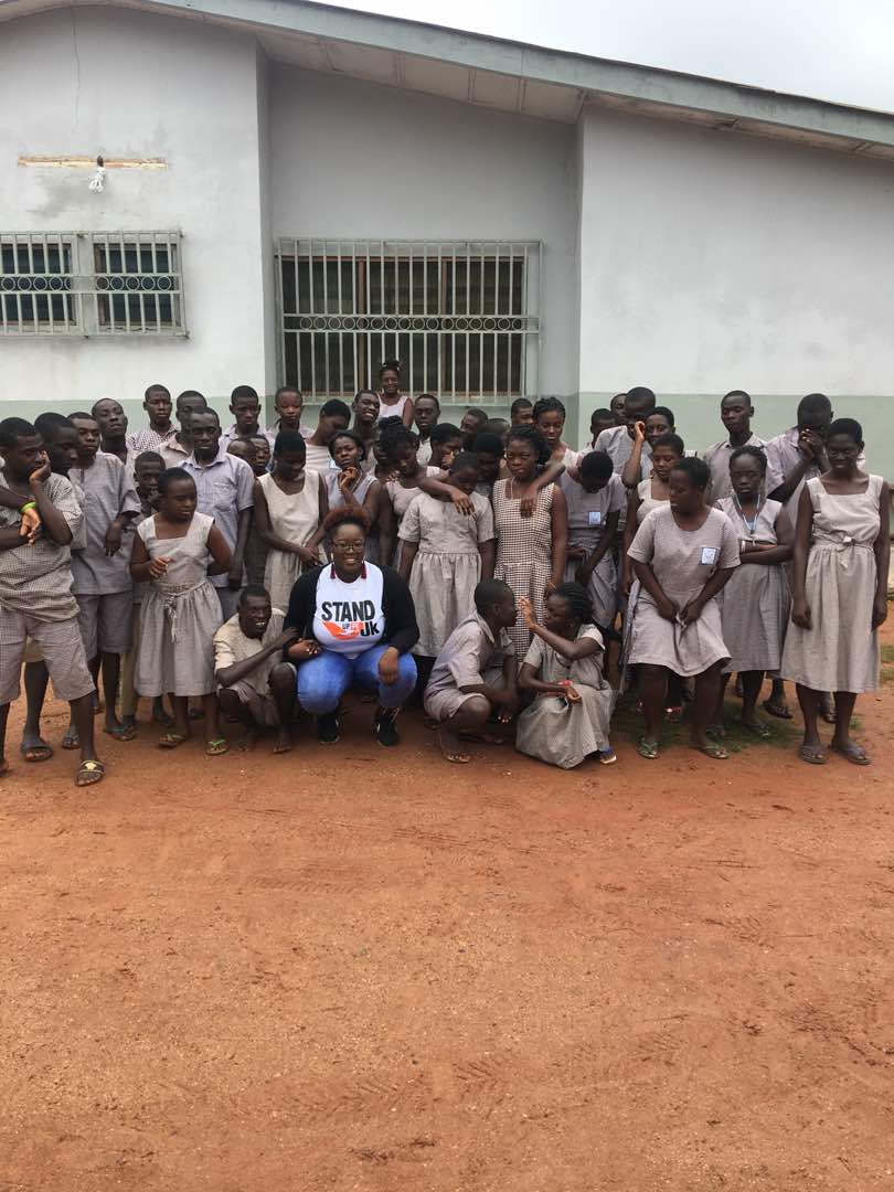 Emily Adusei joins the special children for a photo.