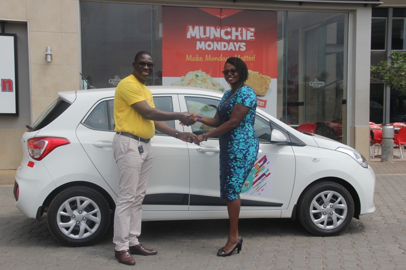 Mr. Oduro-Konadu presents the car keys to winning shopper, Mrs Susan Asiama-Bekoe