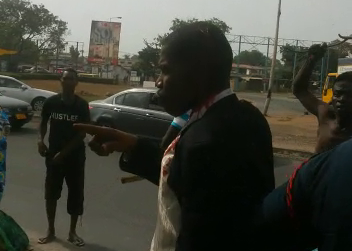 Francis Nabegmado in the grips of police after the murder