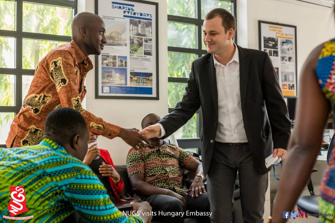Tinkaro Asare Osei (L) in a handshake with David Bekesi  (R)