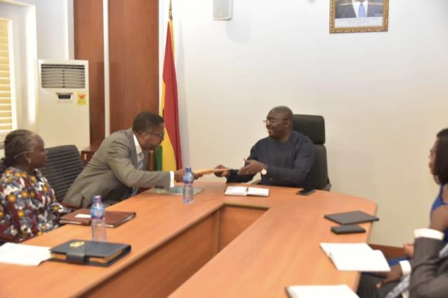 Mr. Charles Zwennes presenting the report to the Vice President.