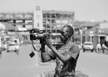 A journalist at work with his camera. Wikimedia Commons