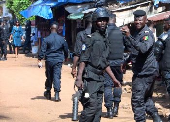Police officers outside the court in Conakry, capital of Guinea [Saliou Samb/Reuters]