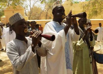 No-one has got married in a village in Kano state, Nigeria, in the past four months after its chief imposed a wedding tax. Ado Sa'id, the chief of Kera village in north-west Nigeria, wants grooms to pay 137,000 naira ($377, £294). This is instead of the current custom of the groom giving presents like furniture and kitchen ware to the bride's family when they get married. The chief told me that the tax is cheaper and intended to make it easier to get married. He said that it was implemented after consultation with villagers, but parents deny this. Villagers feel that under the previous custom grooms had plenty of time to buy gifts at their own pace. One villager, Isah Kera, said the new rule has forced some couples out of the village to go and get married elsewhere. Another villager, Sani Kera said he has five children who are ready for marriage, but the tax has made them suspend their plans.