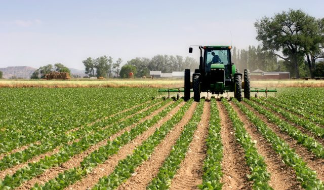 farmer on his tractor plowing the field, rural wyoming