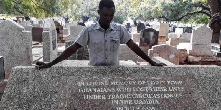 Massacre survivor Martin Kyere at Accra cemetery where six bodies were returned from Gambia.  © 2018 Bénédict De Moerloose/TRIAL International