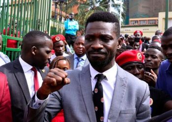Ugandan musician turned politician, Robert Kyagulanyi also known as Bobi Wine gestures as he leaves the Buganda Road Chief Magistrate Court, in Kampala, Uganda February 24, 2020. REUTERS/Abubaker Lubowa/File Photo.