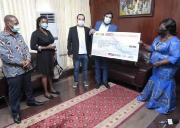 Mr. Hussein Jabir presenting the cheque to the Chief of Staff, Frema Osei Opare