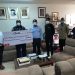 Prof. Anang (middle) receiving the cheque from Mr. Baffour Kwakye (right) while officials of the two institutions looks on.