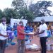 Mr. Yussif Amankwa (right), Branch Operations Manager, Olam Cashew, hands over the supplies to Mr. Opoku Donyina (middle) District Director of Education, Nkoranza North as Mr. Rowell Weroyi, Zonal Head, Cashew looks on.
