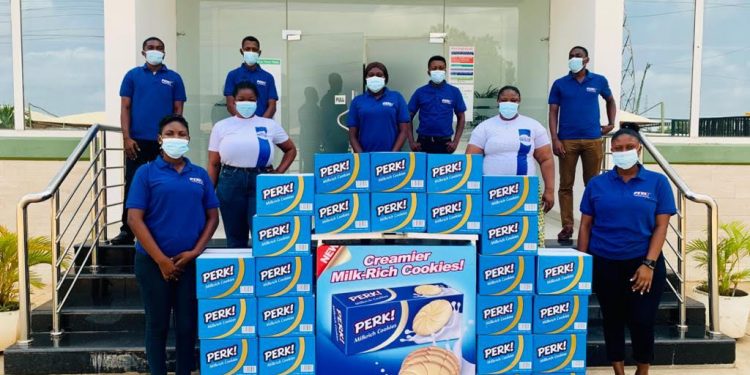 Staff of Nutrifoods Ghana pose with samples of Perk Milkrich Biscuits