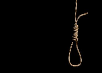A fabric low poly suicide rope with slipknot placed on the white concrete wall with white space on left. 3D illustration and rendered by program Blender.