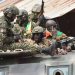 Members of Guinea's armed forces celebrate after the arrest of Guinea's president, Alpha Conde, in a coup d'etat in Conakry on September 5, 2021. - Guinean special forces seized power in a coup on September 5, arresting the president and imposing an indefinite curfew in the poor west African country.
"We have decided, after having taken the president, to dissolve the constitution," said a uniformed officer flanked by soldiers toting assault rifles in a video sent to AFP. (Photo by CELLOU BINANI / AFP)