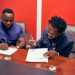 CEO of The Makers Electronics, Stephen Essoun, signing the deal with Fameye.