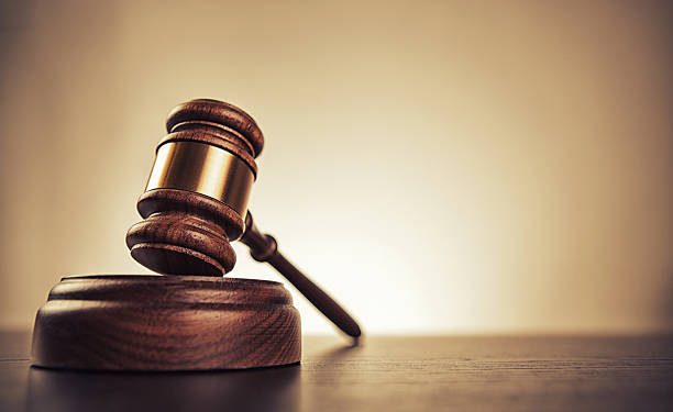 Gavel on desk. Isolated with good copy space. Dramatic lighting.