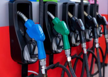 Fuel Pump, Gas Station, Gasoline. Colorful Petrol pump filling nozzles isolated on white background , Gas station in a service in warm sunset. Head fuel vehicle refueling facility in Asia