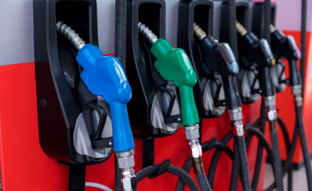 Fuel Pump, Gas Station, Gasoline. Colorful Petrol pump filling nozzles isolated on white background , Gas station in a service in warm sunset. Head fuel vehicle refueling facility in Asia