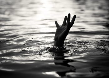 Black and white of Drowning victims Hand of drowning man needing help. Failure and rescue concept.