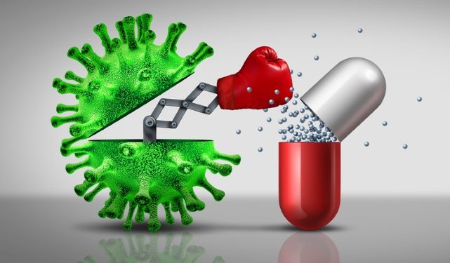 Antibiotic resistant virus as a deadly mutated viral cell attacking a pharmaceutical pill with a punch as a medical pathology disease risk as a 3D illustration