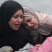 Women at Al-Aqsa hospital in central Gaza mourn their loved ones killed in what Hamas says was an Israeli strike on the Al-Maghazi refugee camp on Sunday