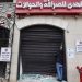 A Palestinian man inspects the damage to a money exchange shop in Ramallah