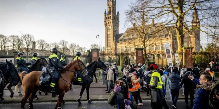 Police disperse protesters outside the ICJ in The Hague