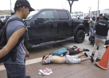 Men lie face down on the ground, detained by police outside TC Television, after a producer told police that they were part of a group who broke onto their set on live TV. Cesar Munoz/Copyright 2024. The AP. All rights reserved
© Provided by Africanews