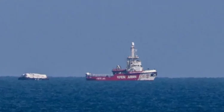 A ship towing 200 tons of aid is visible off the Gaza coast in a pilot voyage aimed at opening up a maritime route for aid