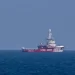 A ship towing 200 tons of aid is visible off the Gaza coast in a pilot voyage aimed at opening up a maritime route for aid
