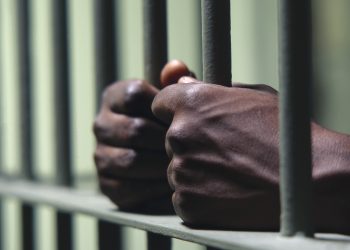 A prisoner's hands pictured clutching the bars of his cell.
Crime Law and Justice
bars
crime
Crime
Justice
time
hands
bars
justice
men
hands
Bill
Fritsch
African
American
male
behind
captivity
con
confined
confinement
convict
convicted
criminal
correctional
facility
Law
doing
on
incarcerated
incarceration
indoors
injustice
inside
interior
jail
cell
law
breaker
penal
colony
penitentiary
person
prison
prisoner
punishment
punitive
institution
square
trapped
people
imprison
imprisonment
jail
male
man
African
American
hand
lifestyle
minority
adult
minorities