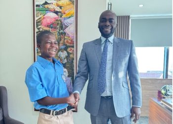Managing Director of Access Bank (Ghana) Plc, Olumide Olatunji in a handshake with young Kwadwo