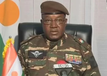 Niger leader Abdourahmane Tchiani wearing a camouflage military shirt, with glasses and a brown beret