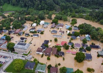 TOPSHOT - Aerial view of homes submerged under flood waters from the North Fork of the Kentucky River in Jackson, Kentucky, on July 28, 2022. - Flash flooding caused by torrential rains has killed at least eight people in eastern Kentucky and left some residents stranded on rooftops and in trees, the governor of the south-central US state said Thursday. (Photo by LEANDRO LOZADA / AFP) (Photo by LEANDRO LOZADA/AFP via Getty Images)