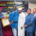 Presenting the award is the President of the Ghana National Chamber of Commerce and Industry, Mr. Stephane Miezan