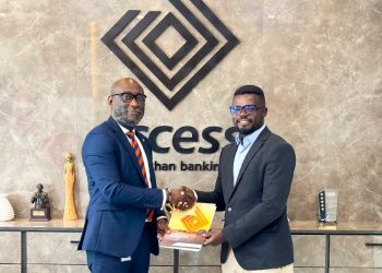Edward Nelson-Addy (Head, Corporate Communications & Brand Management) in a handshake with Annor James Tetteh (Nana Tea)