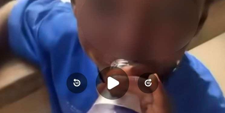 toddler being given alcohol 