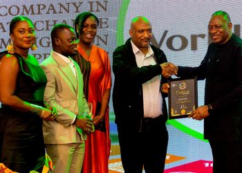 Labour and employment Minister, Rashid Pelpuo presenting an award to World Vision Ghana