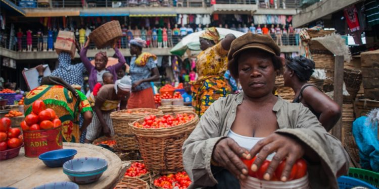 A market woman selling tomatoes in one of Ghana's market