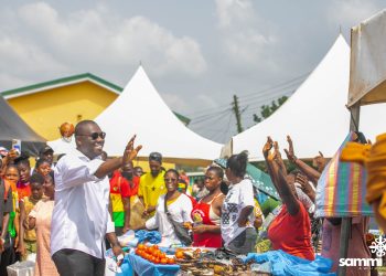 Akuapem North Member of Parliament, Sammi Awuku waving at some shoppers and traders