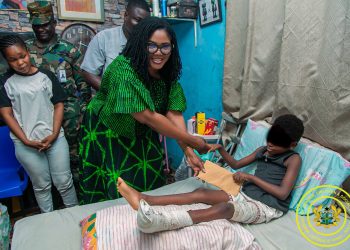Minister for Gender, Children and Social Protection, Dr. Agnes Naa Momo Lartey with alila Abdul Jalil student of St. Olives Grammar Boarding School