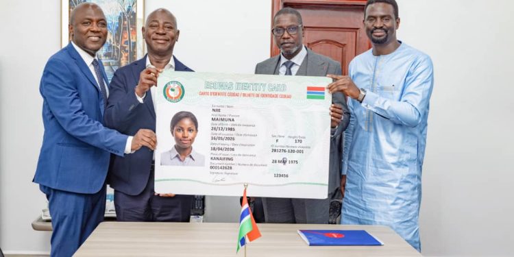 Moses Kwesi Baiden Jr., CEO of Margins ID Group, and Kwesi Baiden, Deputy CEO, with Hon. Abdoulie Sanyang, Minister of Interior of The Gambia, and Permanent Secretary Matar Ceesay, pictured holding a sample representation of the Gambia National Identification Card at the official contract signing ceremony.