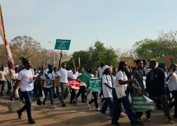 Parents, students and staff of Savannah International Academy walking on the streets of Tamale