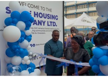 The Minister for Works, Housing and Water Resources, Kenneth Gilbert Adjei (left), cutting the tape with the widow of the late Dr. Samuel Sarpong, former NDC Vice Chairman.