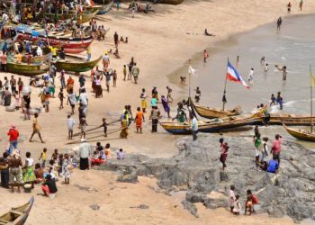 People wait for the fishermen to return with their catch , Anomabo beach, Ghana