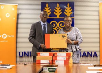 Julian Opuni, Managing Director of Fidelity Bank presenting the laptops to the vice chancellor, Professor Nana Aba Appiah Amfo