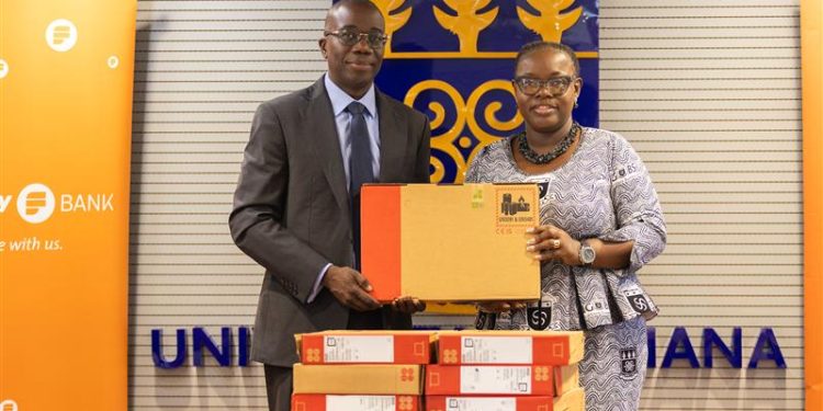 Julian Opuni, Managing Director of Fidelity Bank presenting the laptops to the vice chancellor, Professor Nana Aba Appiah Amfo