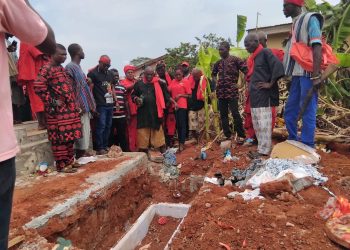 Weta Traditional Authorities performing pacification rituals at the graveside