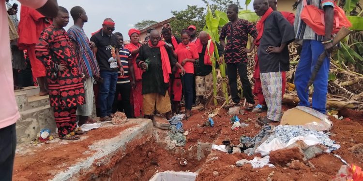 Weta Traditional Authorities performing pacification rituals at the graveside